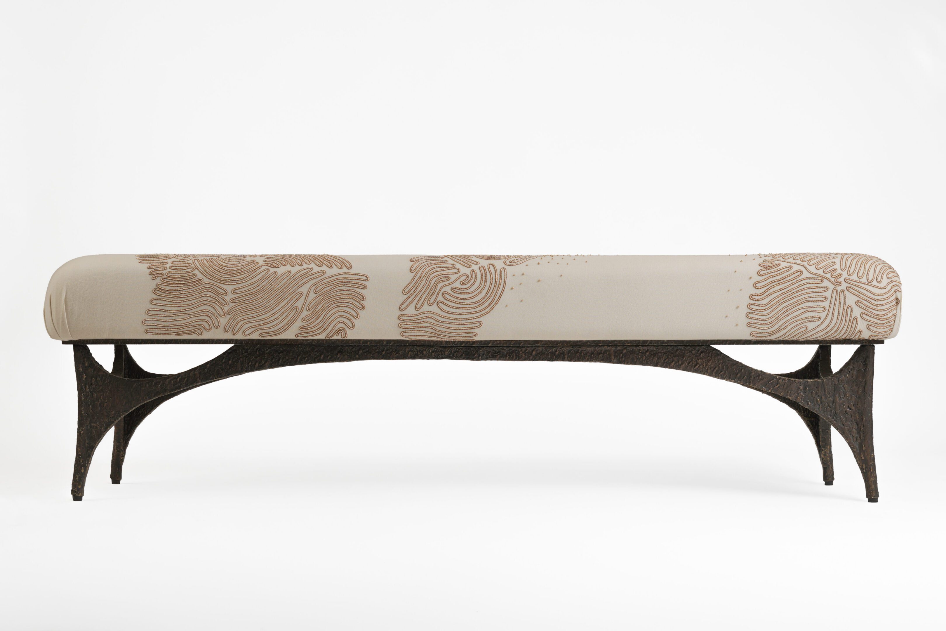 Upholstered bench with carved wooden base