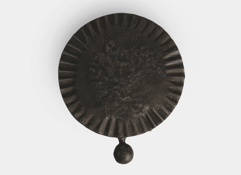 Circular iron object with textured surface