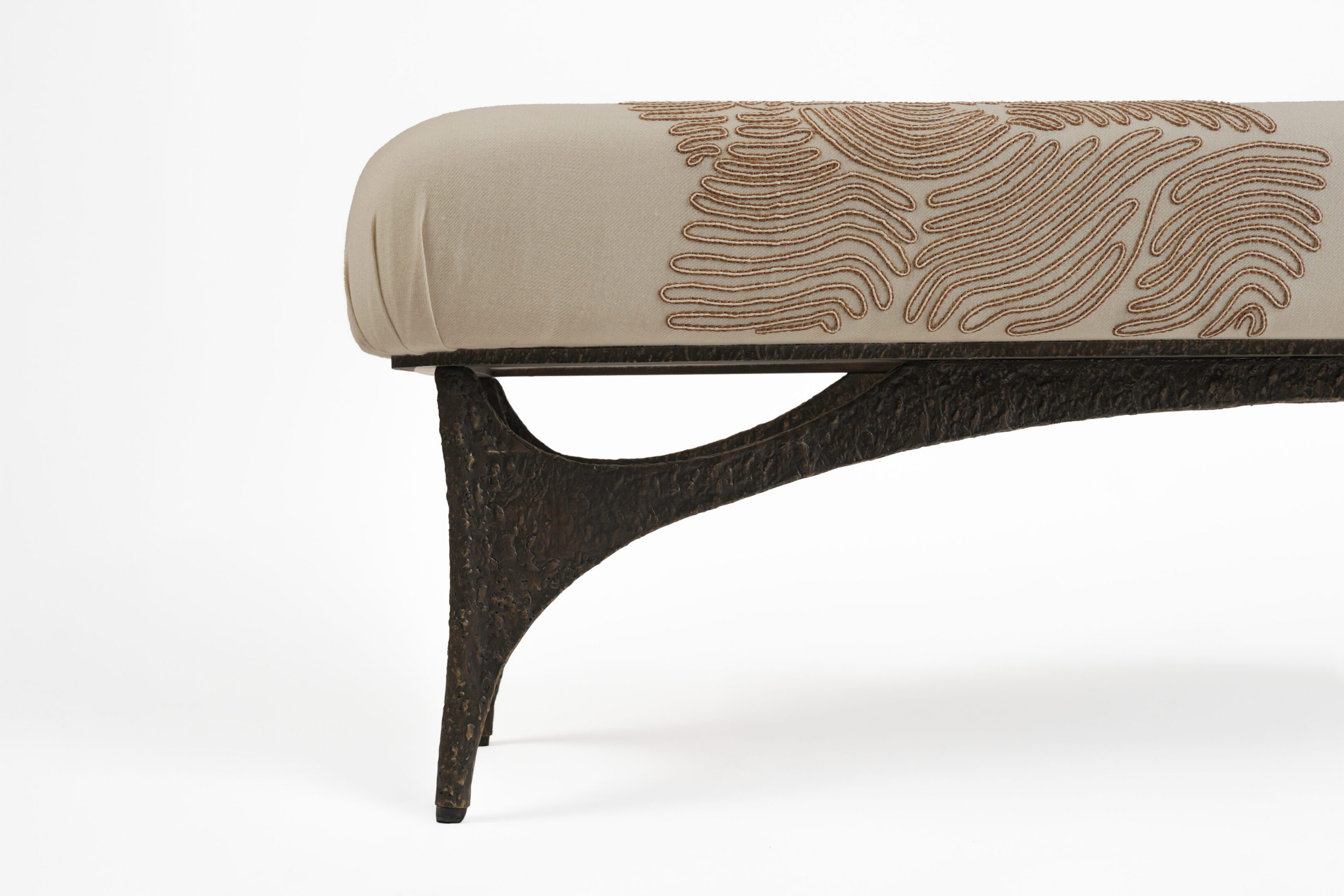Beige embroidered upholstered bench with dark leg