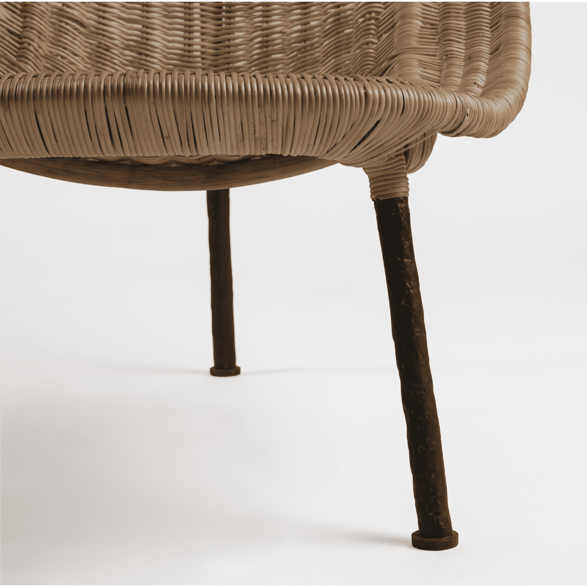 Close-up of wicker chair with metal legs