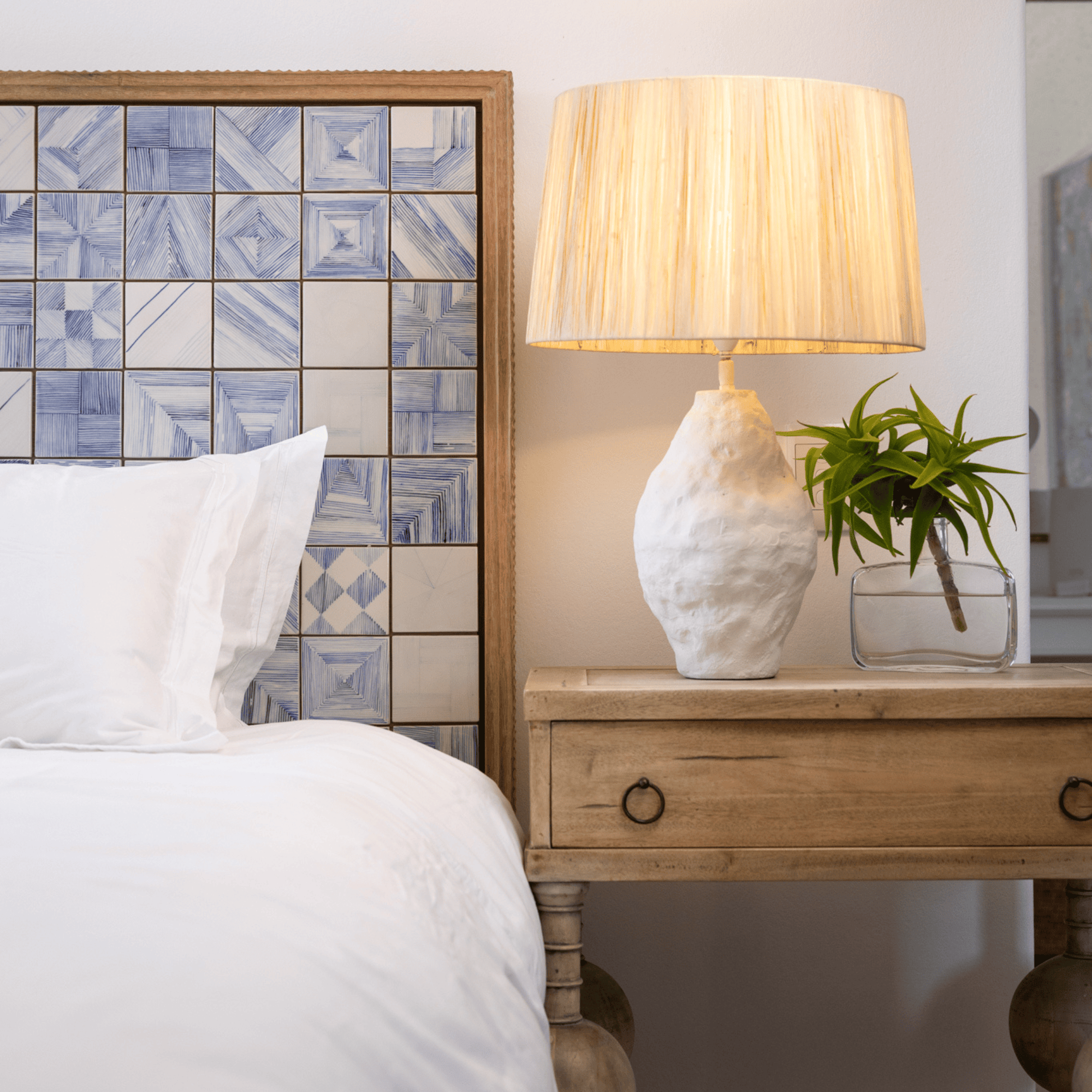 Cozy bedroom with bedside lamp and tiled headboard